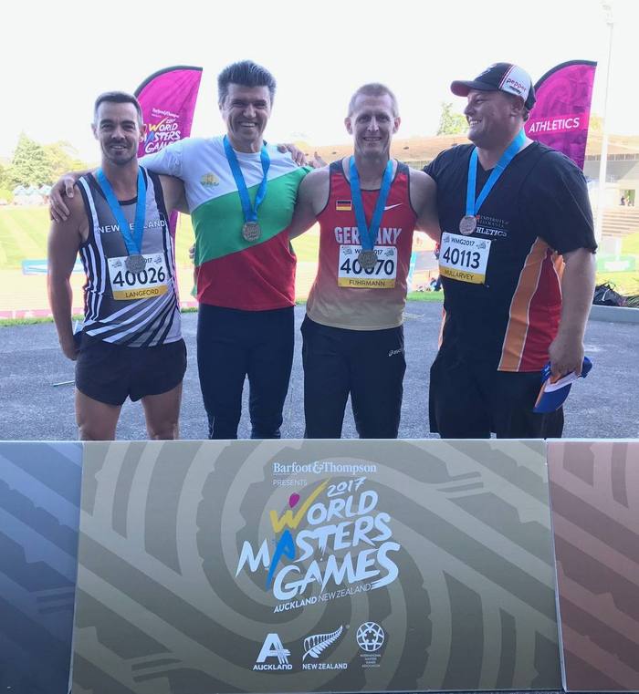 Peter Ivanov on the podium at the 2017 World Masters Games discus throw event